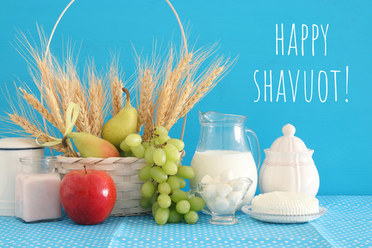 image of dairy products and fruits over wooden table. Symbols of jewish holiday - Shavuot.