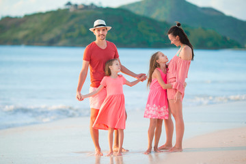 Happy beautiful family on white beach