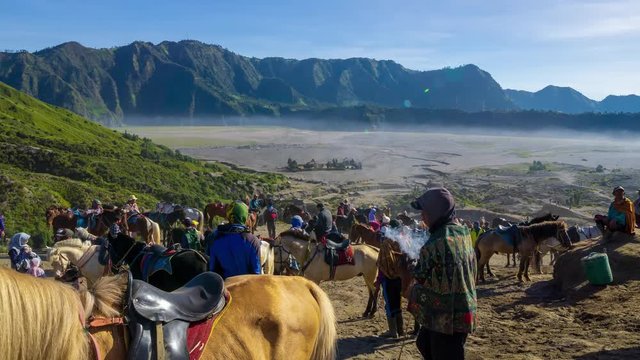 BROMO, INDONESIA - 16th APRIL 2018; 4K Time lapse of Bromo horsemen and foggy morning over mountain range at Mount Bromo, Semeru, Tengger National Park, Indonesia. Zoom In