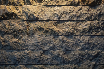 Stone wall under light. Abstract dark wall background.