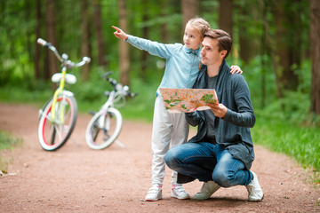 Happy family biking outdoors at the park