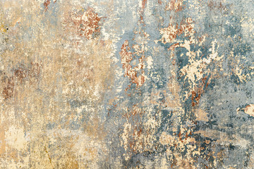 old grunge wall of an old house with remainings of color