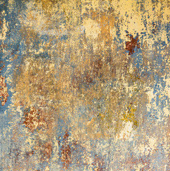 old grunge wall of an old house with remainings of color