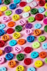 different color buttons on pink background. pastel color