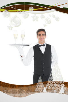 Young waiter presenting a silver tray against christmas frame