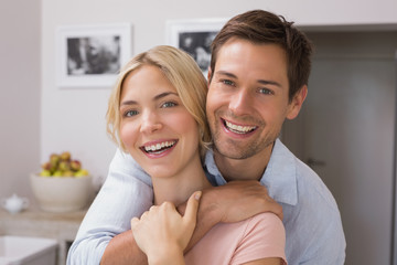 Fototapeta premium Happy loving young couple in the kitchen