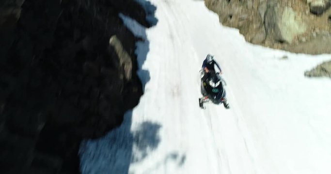 Man Riding Snowmobile Sunny Spring Day Snowy Trail Aerial Drone View