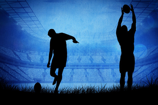 Silhouette of rugby player against rugby stadium