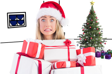 Festive blonde holding pile of gifts against living room sketch at christmas