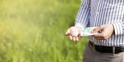 Cute little piggy bank in your hand