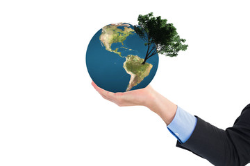 Close up of businessman with empty hand open against tree with green leaves growing