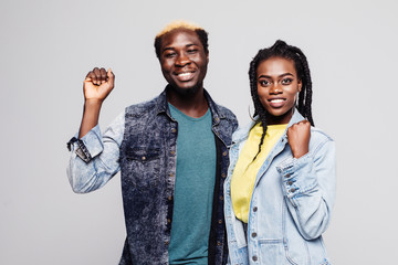 Portrait of a happy young afro american couple screaming and celebrating isolated over white background