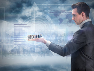 Business people standing up held by giant businessman against room with large window looking on city