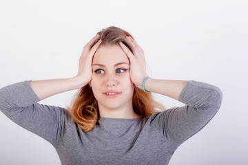 Beautiful young woman with headache touching her temples