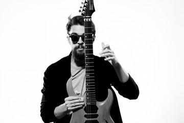 musician in glasses holding an electric guitar