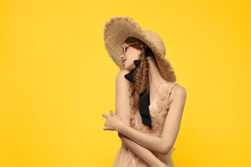 bright woman in glasses with a hat on a yellow background spring style fashion