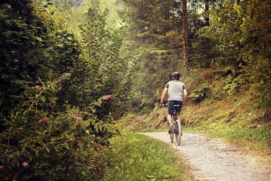 mountain bike training with copy space, warm tone image of a young man working out on a off road path