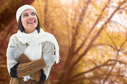 Brunette in warm clothing against tranquil autumn scene in forest