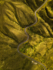 Aerial, birds eye view photo about a mountain road, with red car.