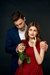 elegant man in a woman suit and a rose