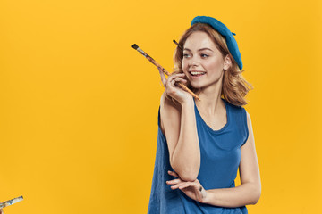 artist with a brush on a yellow background - obrazy, fototapety, plakaty