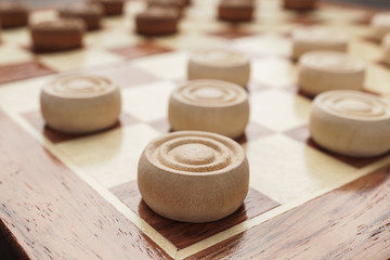 Obraz na płótnie Canvas wooden draughts board game on brown table