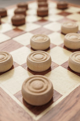 Obraz na płótnie Canvas wooden draughts board game on brown table