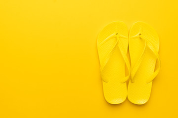 beach flip-flops on the yellow background with copy space. summer is concept
