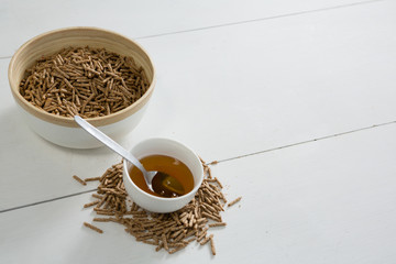 Cereal bran sticks and honey in bowl