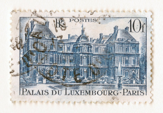 An old blue vintage french postage stamp with an image the palace of Luxembourg in Paris