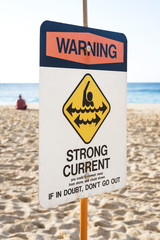 A Warning Strong Current sign at the beach in the north shore of Oahu, Hawaii