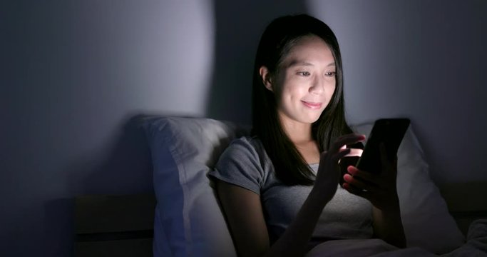 woman use of mobile phone at night