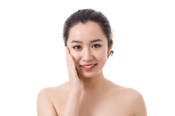 Beautiful face of young smiling woman with clean fresh skin. Touching face.