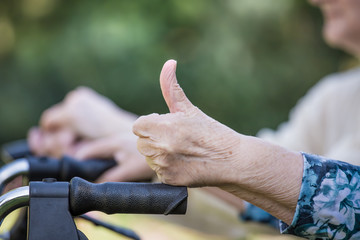 Pensioners sit side by side
