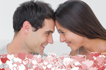 Obraz na płótnie Canvas Couple facing each other against valentines heart design