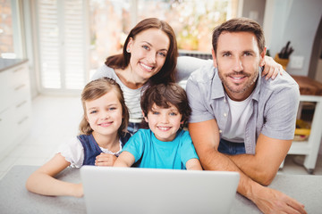 Portrait of happy family with laptop