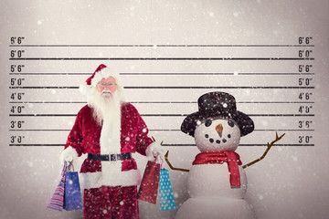 Santa carries some christmas bags against mug shot background