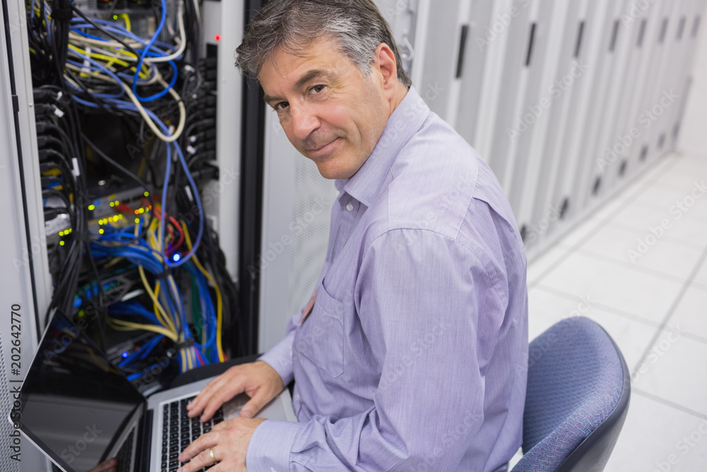 Poster Man doing server maintenance with notebook