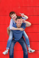 Man giving girl a piggy back against red wooden planks
