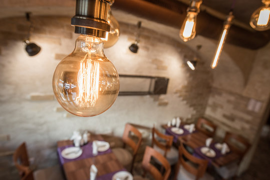Bulbs hanging on ceiling in restaurant interior