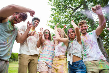 Happy friends throwing powder paint