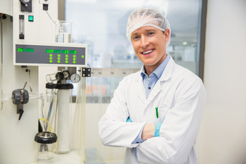 Pharmacist using machinery to make medicine