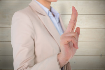 Businesswoman touching against bleached wooden planks background
