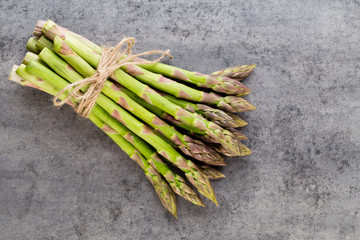 Bunch of fresh asparagus on wooden table.
