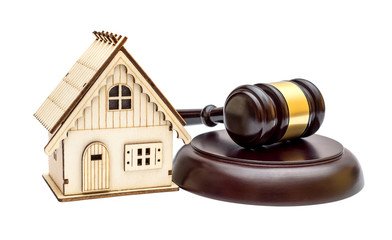 Model of house with judge's gavel and stand isolated on white. Real estate law. Real estate auction concept.