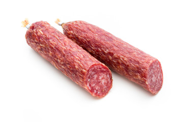 Salami smoked sausage, basil leaves and peppercorns isolated on white background.