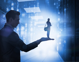 Attractive student holding books and her bag held by giant businessman while standing against matrix falling in data center