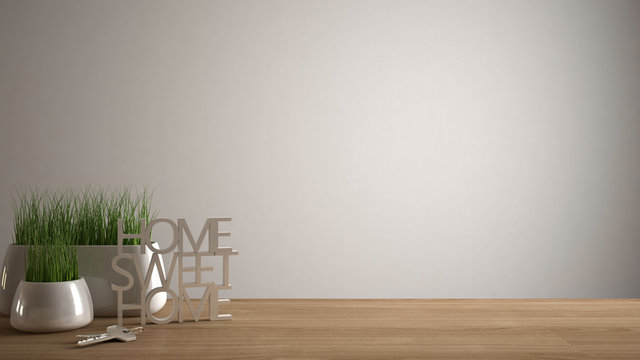 Wooden table, desk or shelf with potted grass plant, house keys and 3D letters making the words home sweet home, white blank copy space background