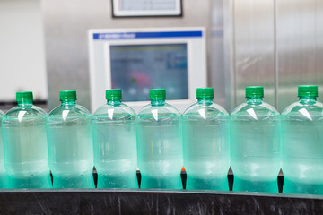 Bottling plant - Water bottling line for processing and bottling pure spring water into bottles. Selective focus. 