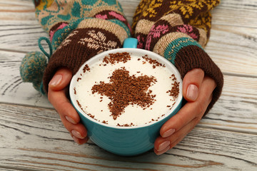 Woman hands hold full latte cappuccino coffee cup